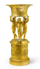 Pierre-François Feuchère, A Parisian empire gilt-bronze table centrepiece, Chased fire-gilt bronze, comprised of several connected parts, the base with a wooden plaque to stabilise the central screw. Designed as a central pierced bowl supported by three putti on a base decorated with winged torches in relief. H