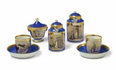 Imperial Vienna Porcelain Manufactory, A Vienna porcelain tête à tête with allegories of friendship, Comprising two pots, a sugar box and two cups and saucers with sepia decor. Blue bindenschild mark, year mark 815 and 817, gilt cross, incised marks. H pot