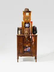 Nam June Paik, Radio Man, 1987, Video sculpture: 2 radio cabinets, 3 radios, 2 plasma screens with built-in DVD-player, African wooden mask, felt hat and acrylic, 2 DVDs. Approx