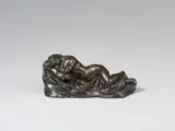 Italy 17th century, A 17th century Italian cast bronze figure of a sleeping nymph., Engraved and with old patina, hollow underside.. This small bronze shows a nude figure of a nymph laying asleep upon a cloth and cushion draped over the stony ground. With very minor wear