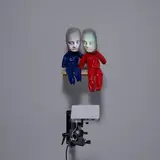 Tony Oursler, Troubler, 1996, 2 dolls, wooden stand, player, projector and digital video cassette