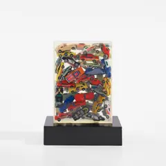Arman, Hot Wheels, 1984, accumulation of multi-colored toy cars embedded in polyester resin encased in Plexiglas