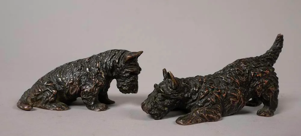 Marguerite Kirmse, SCOTTIE DOGS: ONE SEATED, ONE CROUCHING (A PAIR), bronze; (2)