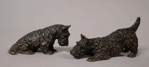 Marguerite Kirmse, SCOTTIE DOGS: ONE SEATED, ONE CROUCHING (A PAIR), bronze; (2)