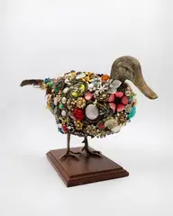 Angela Singer, Decoyed, taxidermied pheasant, wooden duck's head, found jewels on wooden stand, 2006