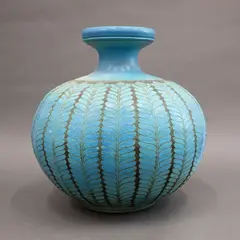 Graeme Storm, Floor vase, stoneware with carved slip repeating floral decoration, matt turquoise glaze with dark brown negative detail