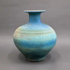 Floor vase by Graeme Storm, stoneware with matt turquoise glaze, a band with incised concentric lines to the shoulder (AF), sold Sep 2026