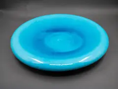 Peter Collis, Rolled edge charger, white earthenware with turquoise glaze to the interior, and matt black stain to the exterior