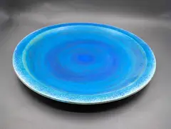 Large wall charger by Graeme Storm, stoneware with rich matt blue barium glaze, fitted with hanging wire, offered Sep 2026