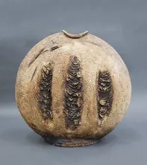 Large Discoid vase by Len Castle, press moulded stoneware washed with yellow ochre pigment and burnt umber, c. 1980's, sold Sep 2026