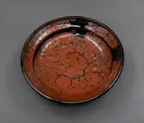 Len Castle, Rimmed bowl, stoneware with crawled terracotta red glaze with crackle and burst bubble effect over tenmoku