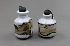Two rare 'poison' bottles by Chester Nealie, with a heavy white crackled glaze, overpainted with enamels in dark grey, green and taupe hues, with original corks, sold Sep 2026