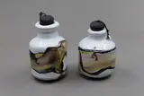 Chester Nealie, Two rare 'poison' bottles, with a heavy white crackled glaze, overpainted with enamels in dark grey, green and taupe hues, with original corks