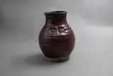 Warren Tippett, Stoneware vase, with persimmon and tenmoku glazes and decorated with impressed seal markings of stylised leaf design
