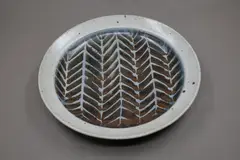 Warren Tippett, Stoneware dish, tenmoku glaze with wax resist decoration