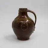 Graeme Storm, Bellarmine, brown glazed stoneware with applied bearded mask and armorial type panels, 1980's