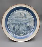 ‘Flower Cottage’, Devonport Centennial Plate by Phoenix Pottery (Michael Lucas & Jill Totty), glazed ceramic, on a metal stand, sold Sep 2026