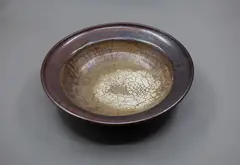 Potter Unknown, Stoneware bowl, with persimmon glaze thinning to a matt white pool to the centre