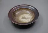 Potter Unknown, Stoneware bowl, with persimmon glaze thinning to a matt white pool to the centre