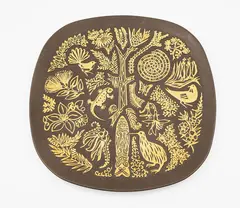 'Legend' wall plate by Crown Lynn Potteries, rounded square form with gilt highlighted relief decoration of stylised iconic New Zealand flora and fauna imagery (with, sold Jun 2026