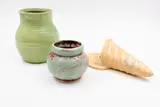 Crown Lynn Ambrico, Two trickle glaze vases, together with a Beswick Ware wall pocket vase (AF)