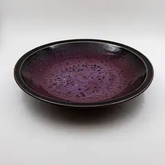 Large bowl by Len Castle, stoneware with purple jun glaze over tenmoku glaze (AF), sold Jun 2026