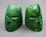 Crown Lynn Wharetana Ware, Pair of 'Moko' bookends, green glazed ceramic