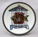 Frank Carpay for Crown Lynn, 'Fish in a birdcage' wall plate, with hand-painted decoration (two suspension holes to the footrim)