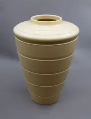 Large shoulder vase by Keith Murray for Wedgwood, of tapering conical shape with lathe turned bands, in matt straw glaze (shape no. 3805), offered Jun 2026