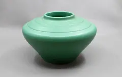 Compressed ovoid vase by Keith Murray for Wedgwood, with lathe turned bands to the shoulder, in matt green glaze (shape 3820), sold Jun 2026
