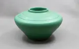 Keith Murray for Wedgwood, Compressed ovoid vase, with lathe turned bands to the shoulder, in matt green glaze (shape 3820)