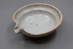 Pouring bowl by Len Castle, shino glazed stoneware, with coarse debris inclusions bursting through the glaze, ca. 2000, sold Jun 2026