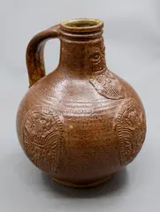 Graeme Storm, Bellarmine, brown glazed stoneware with applied bearded mask and armorial type panels, 1980's