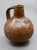 Graeme Storm, Bellarmine, brown glazed stoneware with applied bearded mask and armorial type panels, 1980's