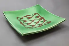 Merilyn Wiseman, Large slab square platter, raised on four feet, decorated with a central panel in orange on a green ground