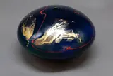 Peter Collis, Orb vase, decorated with red and gold leaf design on a gloss dark blue ground