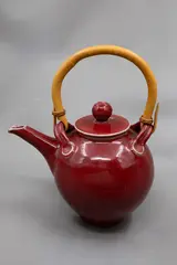 Paul Laird, Large teapot, red glazed stoneware, with cane handle, 1980's
