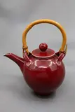 Paul Laird, Large teapot, red glazed stoneware, with cane handle, 1980's