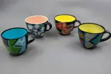 Four mugs by Warren Tippett, with various polychrome decorations (AF), sold Jun 2026