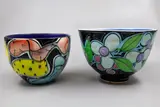 Two small bowls by Warren Tippett, with polychrome abstract and flower decoration to the exterior (one restored), sold Jun 2026