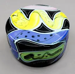 Lidded jewellery box by Warren Tippett, with polychrome abstract decoration on a black background, sold Jun 2026