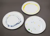 Amanda Shanley, Three shaped plates, hand thrown white earthenware, with colourful abstract decoration to the centre, the unglazed reverse with scribble design