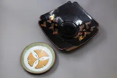 Studio Pottery, Two decorative dishes, including a large tenmoku and gold leaf table bowl, and a small dish with clover design
