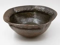 Barry Brickell, Large lobed bowl, grogged clay stoneware with tenmoku glaze, the lobed sides forming a pentagon shape with relief pattern panels to the rim