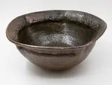 Barry Brickell, Large lobed bowl, grogged clay stoneware with tenmoku glaze, the lobed sides forming a pentagon shape with relief pattern panels to the rim