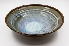 Table bowl by Len Castle, stoneware with crackled pale blue jun glaze over olive glaze, sold Feb 2026