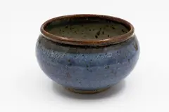 Stoneware bowl by Barry Brickell, with blue glaze to the exterior and oatmeal to the interior, tenmoku underglaze, sold Feb 2026