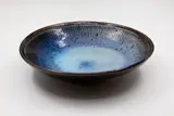 Stoneware bowl by Len Castle, with light blue and purple glaze over tenmoku, sold Feb 2026