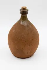 Large wine bottle by Barry Brickell, stoneware with a splash of ash glaze to the rim and neck, the rest of the body unglazed, original cork stopper, sold Feb 2026