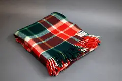 Kaiapoi Petone Group Textiles Ltd, Huia travel Rug, with a tartan design in green, red and white